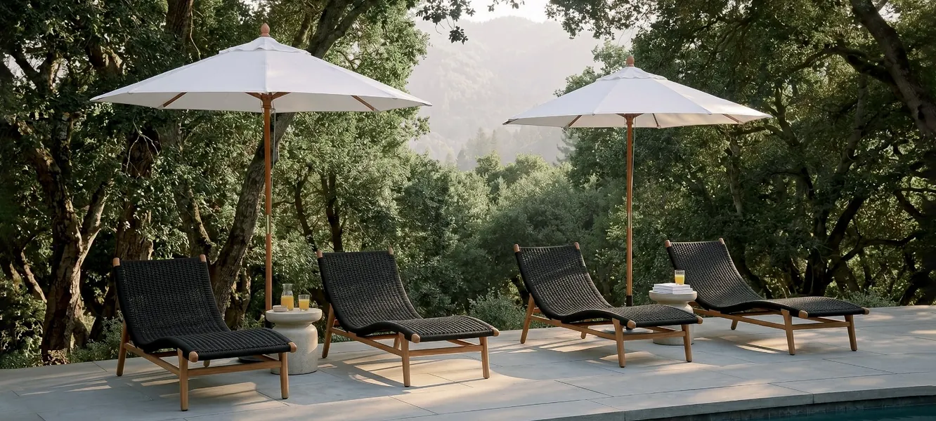 Teak lounge chairs and side tables by a resort pool, by Mobelindo